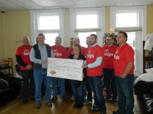 hannaford helps volunteers presenting a large check